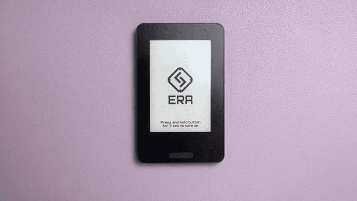 Front of Era hardware wallet placed on a purple surface showing ERA logo on the screen