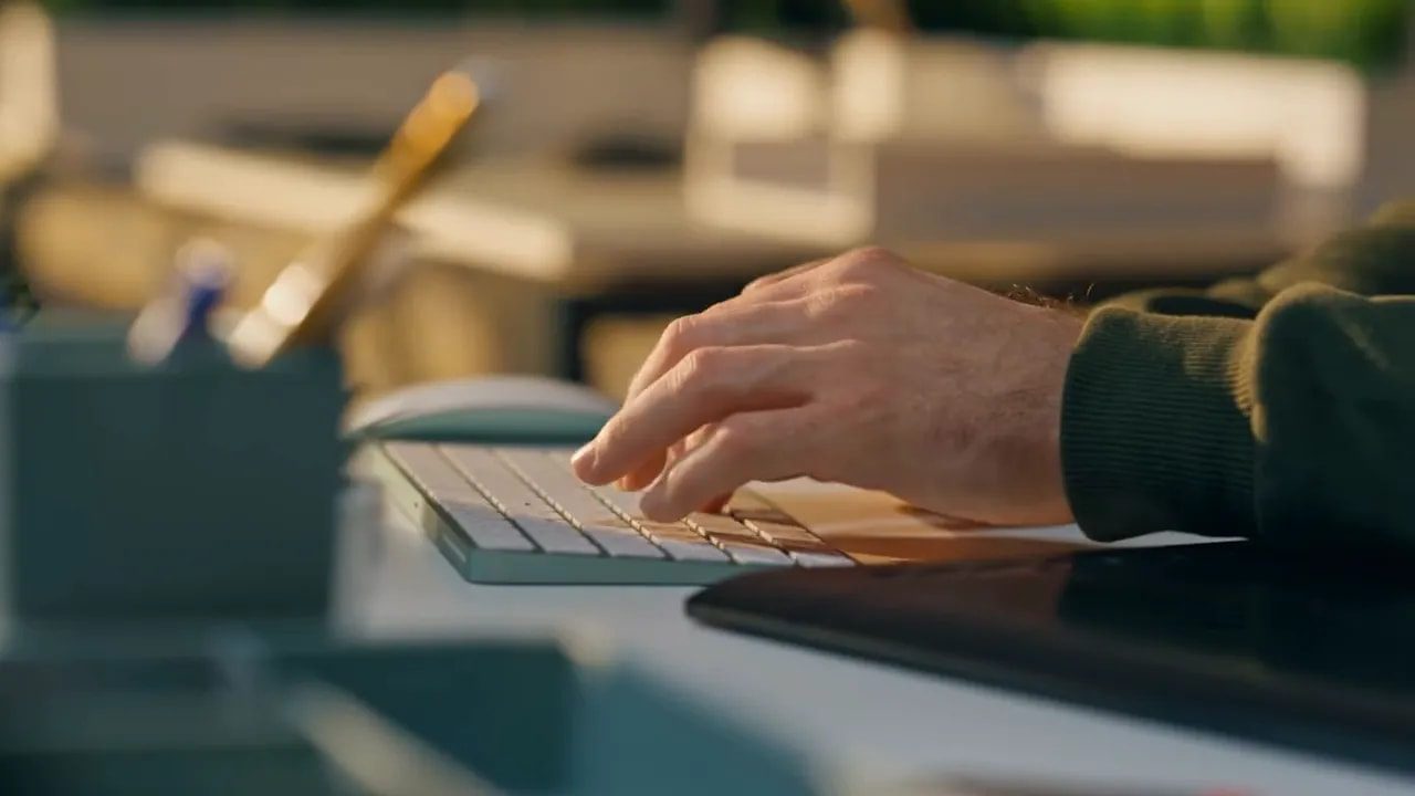 Close-up of hands typing on a computer keyboard